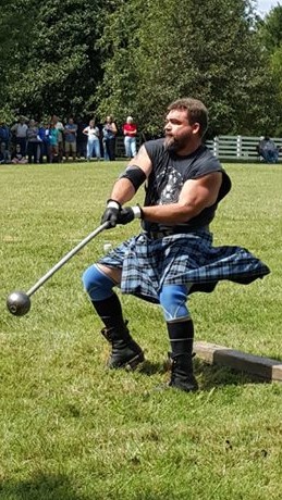 A man in a kilt doing a hammer throw
