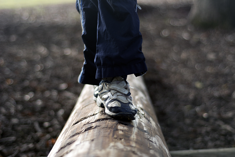 Child walking on a log